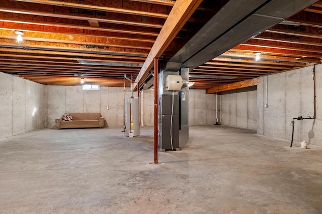 basement featuring water heater and heating unit