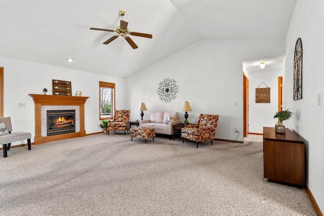 living area with a tiled fireplace, lofted ceiling, light colored carpet, and baseboards