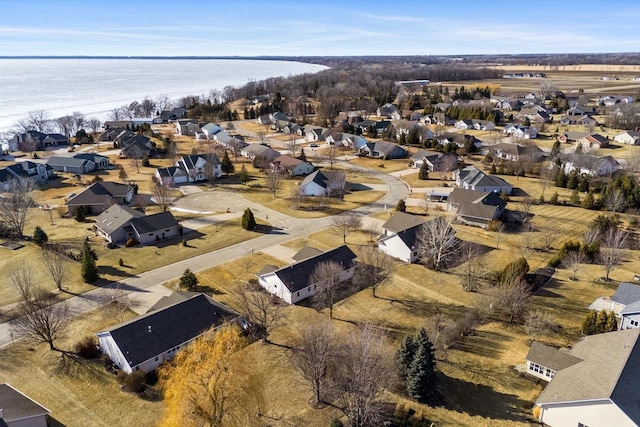 drone / aerial view with a residential view and a water view