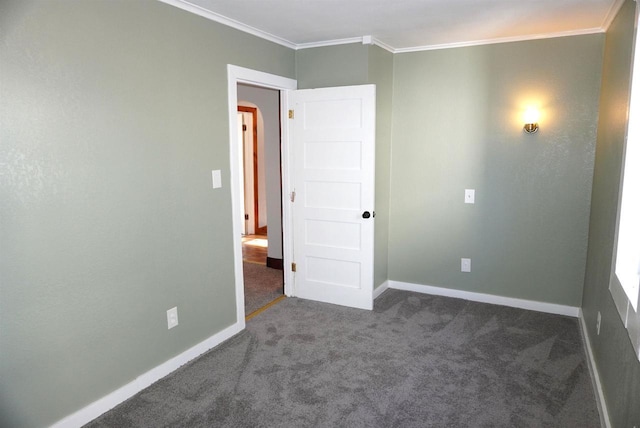 unfurnished room featuring carpet, crown molding, and baseboards