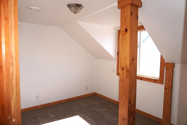 bonus room featuring lofted ceiling, carpet flooring, and baseboards