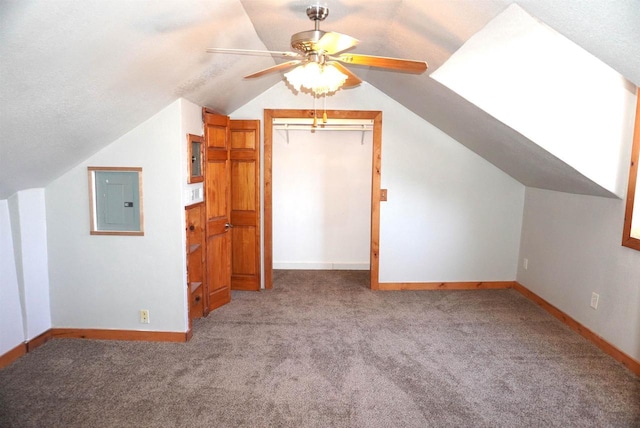 bonus room with ceiling fan, lofted ceiling, baseboards, electric panel, and carpet