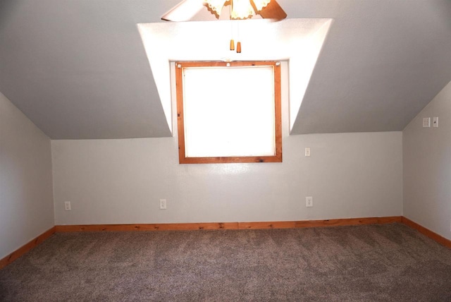 bonus room featuring lofted ceiling, baseboards, and carpet flooring