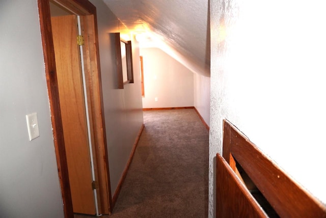 bonus room featuring lofted ceiling, carpet, and baseboards