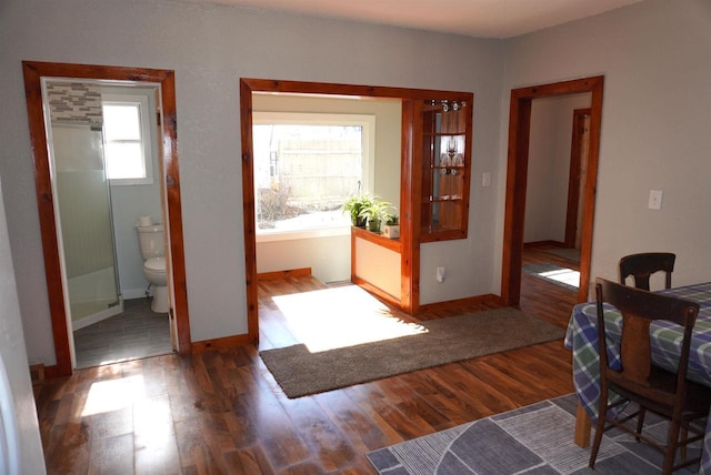 interior space featuring baseboards and wood finished floors