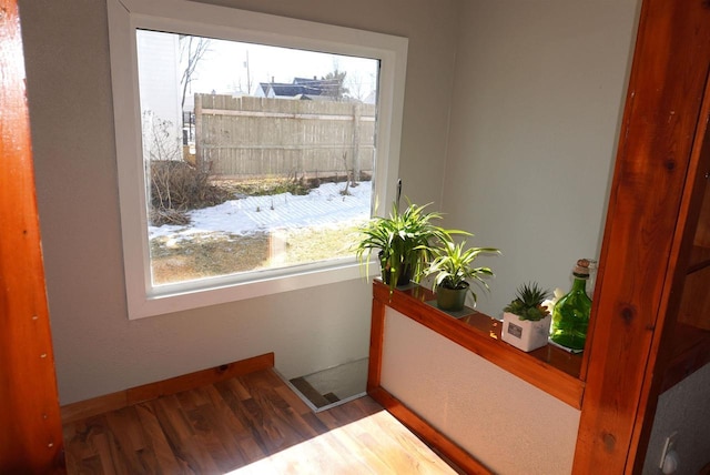 interior space featuring baseboards and wood finished floors