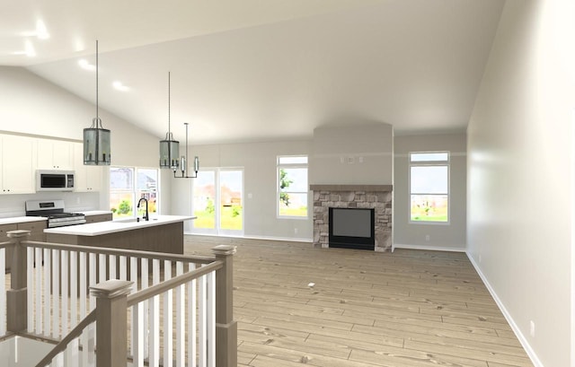 living room featuring high vaulted ceiling, a stone fireplace, light wood-type flooring, and baseboards