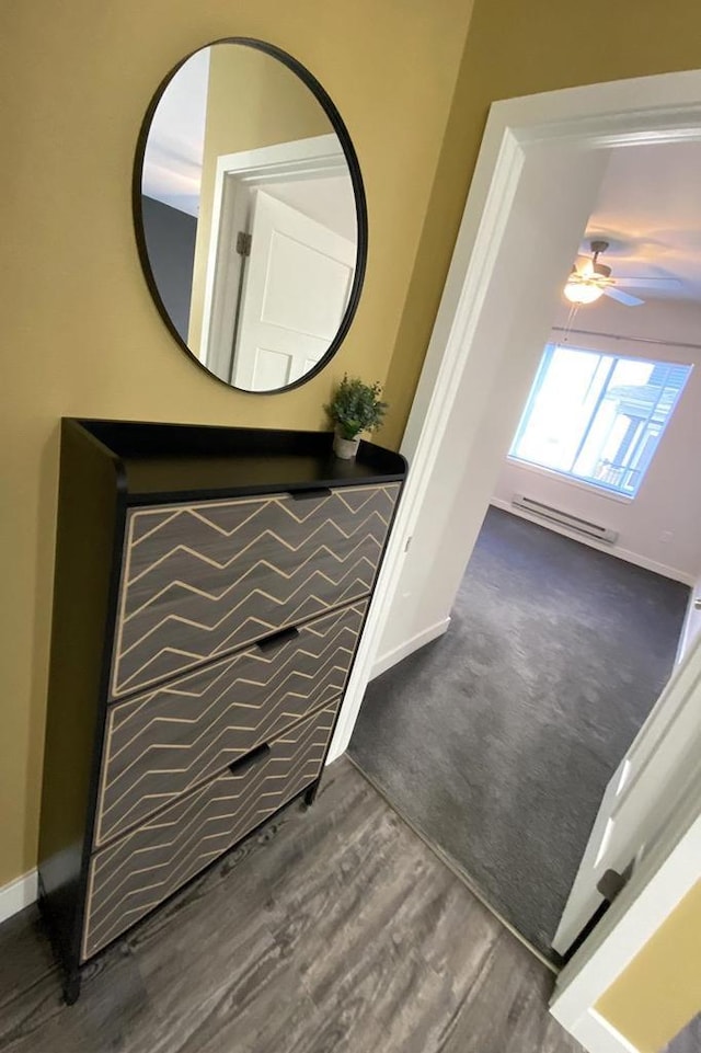 bathroom with ceiling fan, wood finished floors, and baseboards