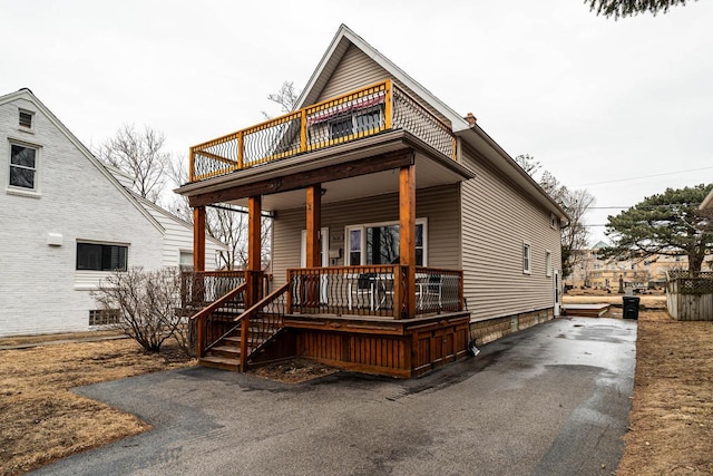 view of front facade featuring a balcony and covered porch