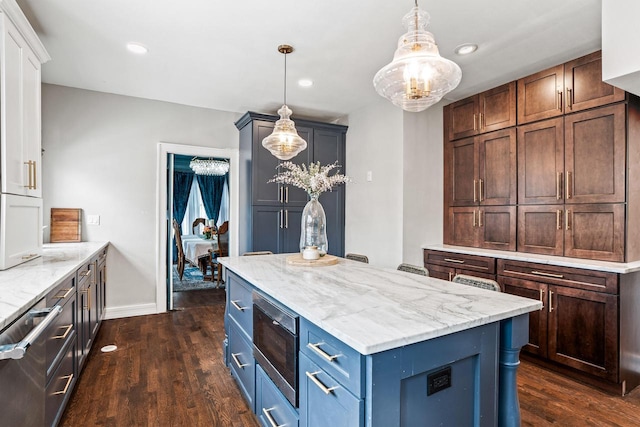 kitchen featuring pendant lighting, recessed lighting, dark wood-type flooring, a kitchen island, and light stone countertops