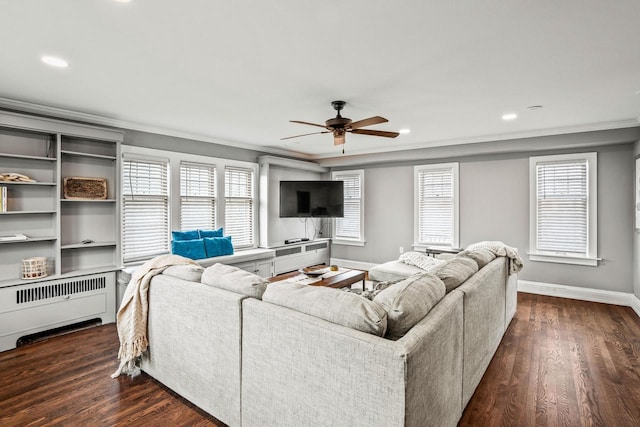 living room with ornamental molding, dark wood-style flooring, baseboards, and radiator heating unit