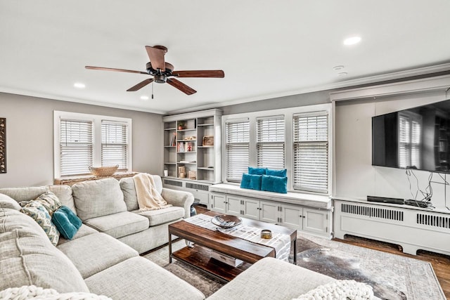 living area featuring a ceiling fan, recessed lighting, crown molding, and wood finished floors