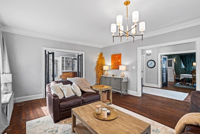 living room with ornamental molding, an inviting chandelier, wood finished floors, and baseboards