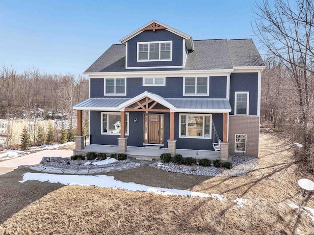 view of front of house featuring covered porch, metal roof, and a standing seam roof