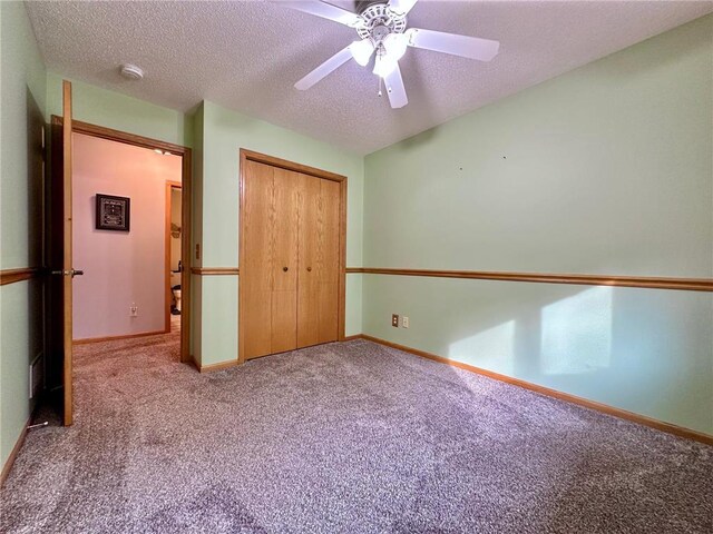 unfurnished bedroom featuring a closet, a textured ceiling, and carpet flooring