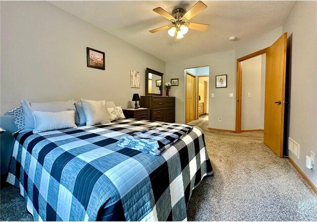 bedroom with visible vents, light carpet, ceiling fan, a textured ceiling, and baseboards