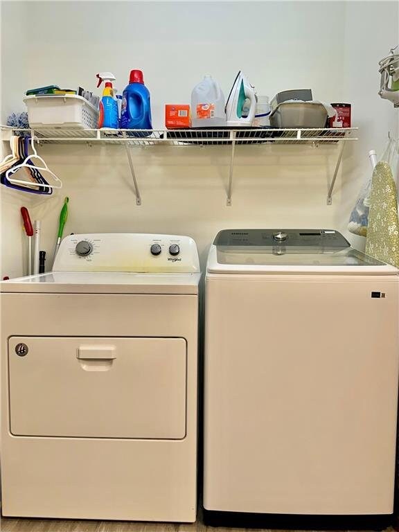 clothes washing area featuring laundry area and washer and dryer