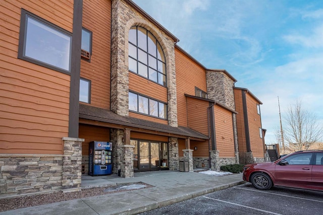 view of building exterior featuring uncovered parking