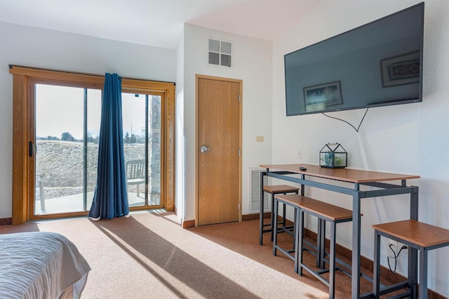 carpeted bedroom featuring access to exterior and visible vents