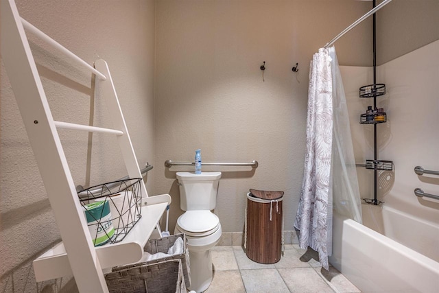 full bath featuring toilet, tile patterned flooring, shower / bath combo, and a textured wall