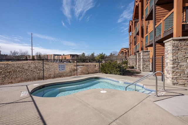 view of pool with fence and a patio