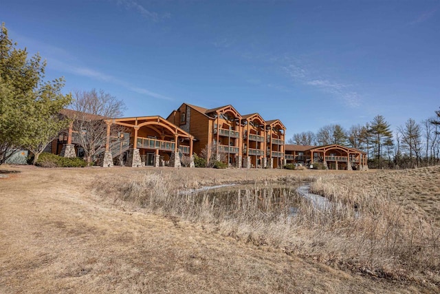 back of property featuring stone siding