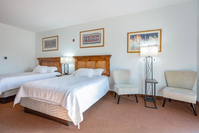 bedroom featuring carpet floors and baseboards