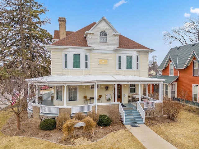 victorian-style house with a chimney and a porch