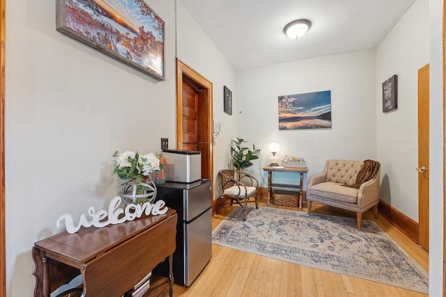 sitting room featuring wood-type flooring and baseboards