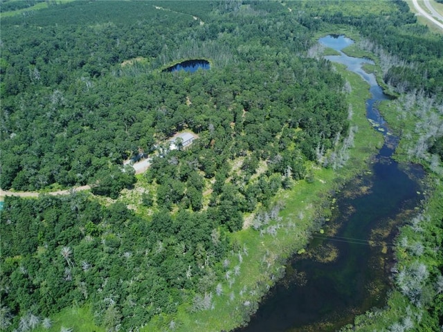 bird's eye view with a water view and a forest view