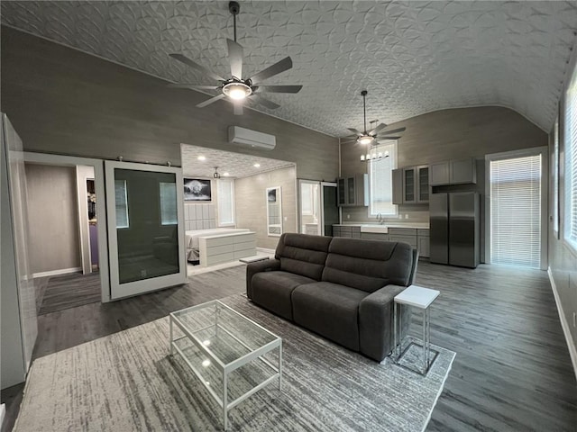 living area featuring high vaulted ceiling, wood finished floors, a ceiling fan, baseboards, and a wall mounted AC