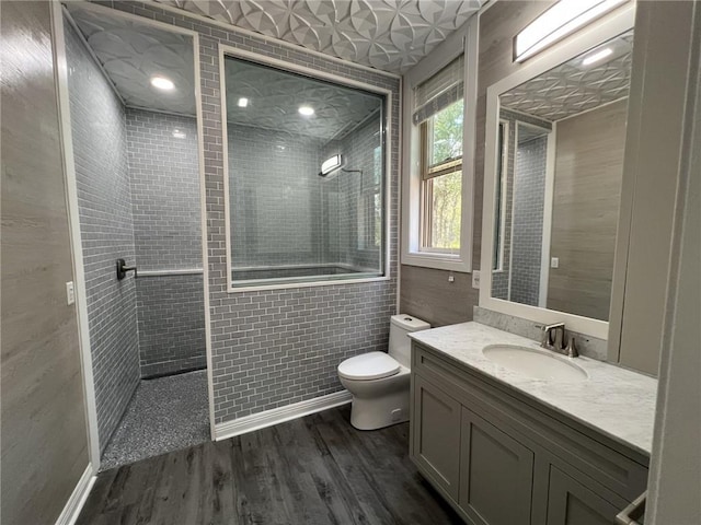 full bath with walk in shower, vanity, toilet, and wood finished floors