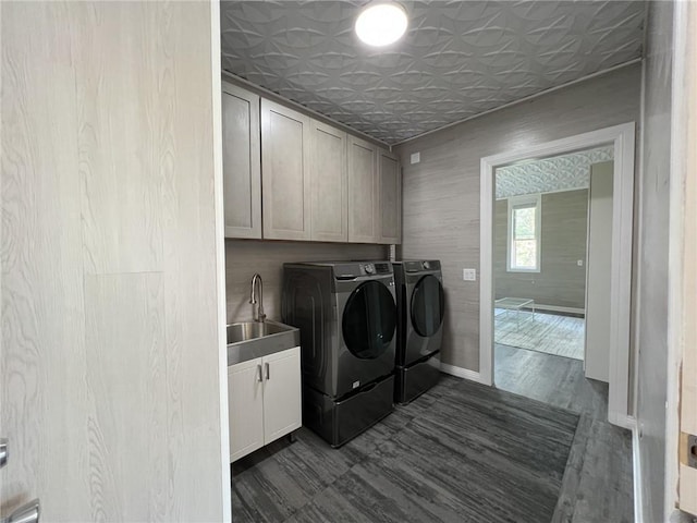 washroom with cabinet space, washer and clothes dryer, an ornate ceiling, dark wood-type flooring, and a sink