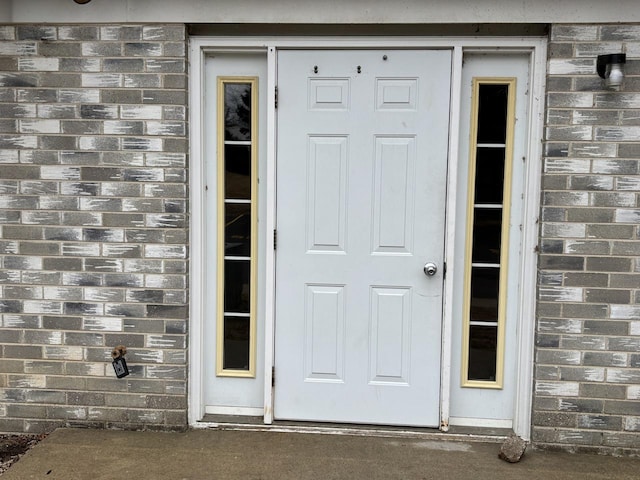 doorway to property featuring stone siding