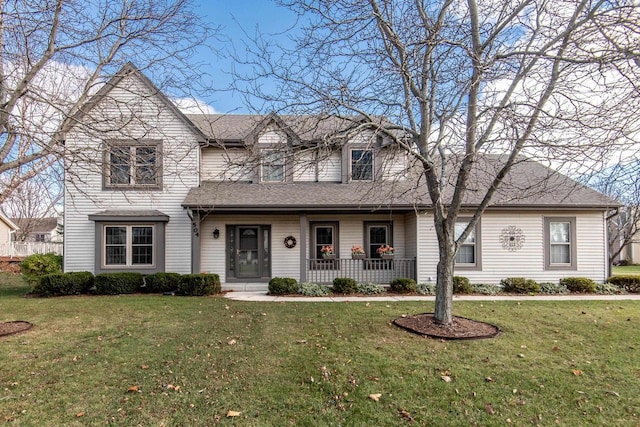 view of front of home featuring a front lawn, a porch, and a shingled roof