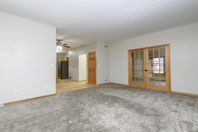 unfurnished room featuring french doors, carpet flooring, visible vents, and baseboards