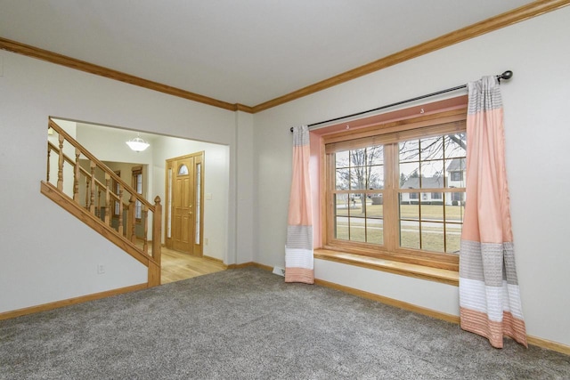 carpeted spare room featuring ornamental molding, baseboards, and stairs