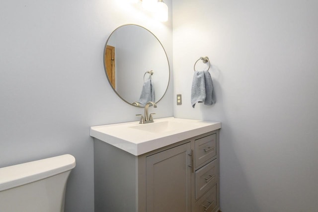 half bathroom with toilet and vanity