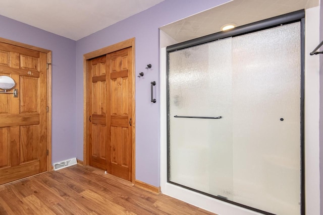 interior space featuring light wood finished floors, baseboards, and visible vents