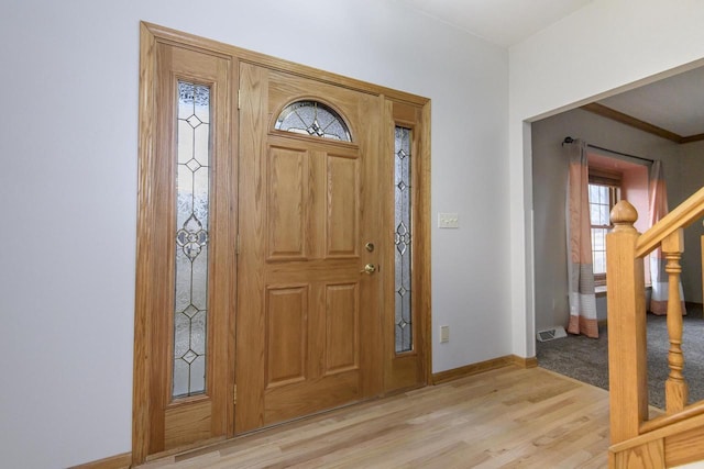 entryway featuring light wood-style flooring, stairs, and baseboards