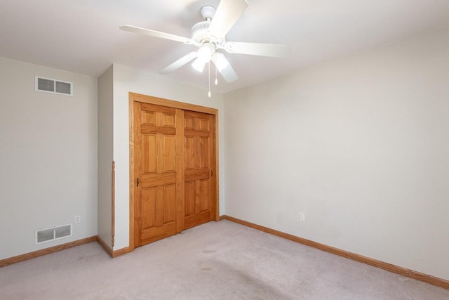 unfurnished bedroom with light colored carpet, visible vents, and baseboards