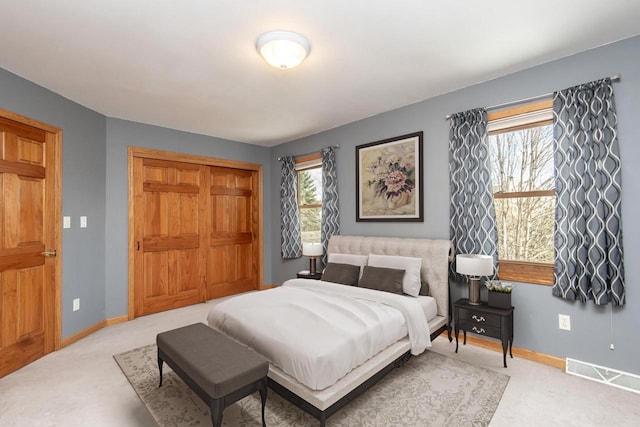 bedroom featuring multiple windows, carpet, visible vents, and baseboards