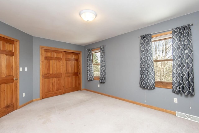 bedroom with carpet, multiple windows, visible vents, and baseboards