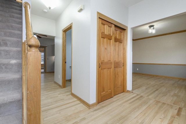 corridor with wood finished floors and baseboards