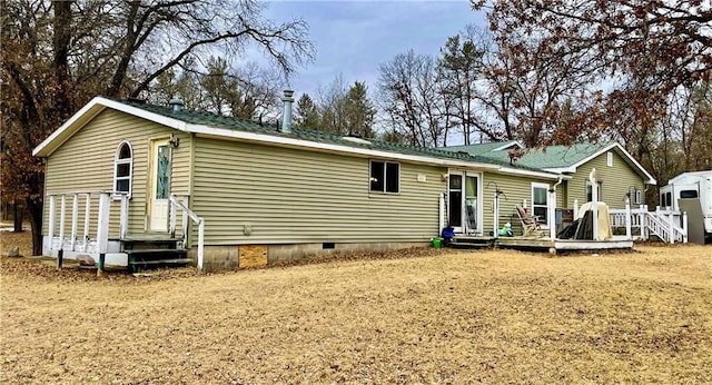 view of front of house featuring entry steps, crawl space, and a deck