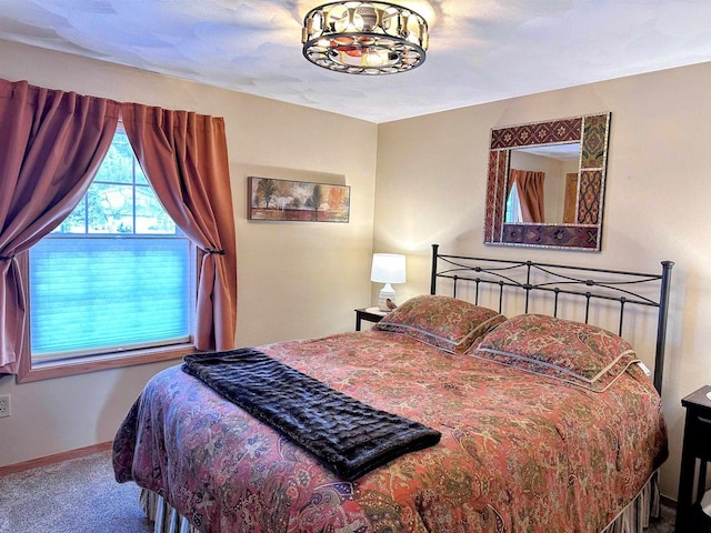 bedroom featuring carpet and baseboards