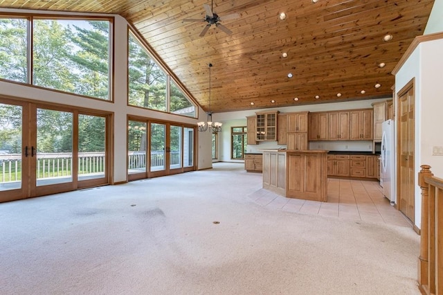 kitchen with light colored carpet, wood ceiling, open floor plan, freestanding refrigerator, and high vaulted ceiling