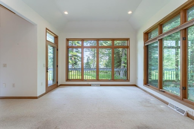 unfurnished sunroom featuring a healthy amount of sunlight, visible vents, and vaulted ceiling