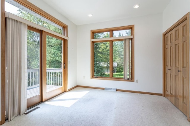 doorway to outside featuring carpet, visible vents, baseboards, and recessed lighting