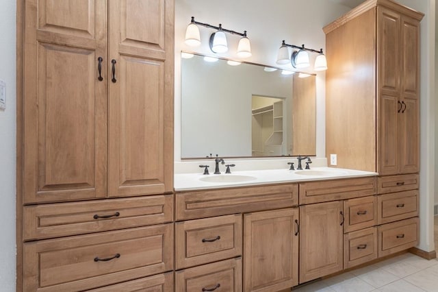 full bathroom featuring a sink, tile patterned flooring, double vanity, and a closet